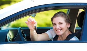 Woman in car holding keys