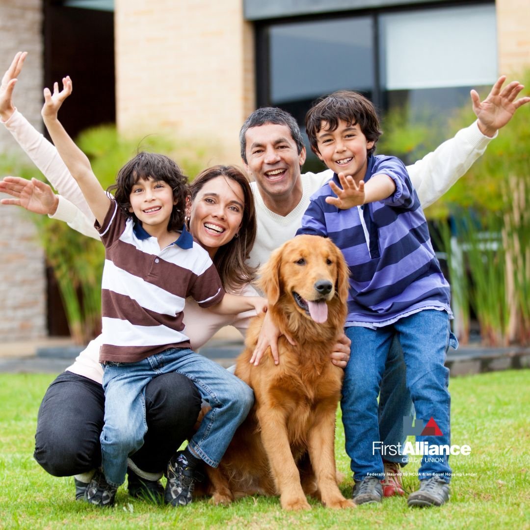 young hispanic family in front of their new home