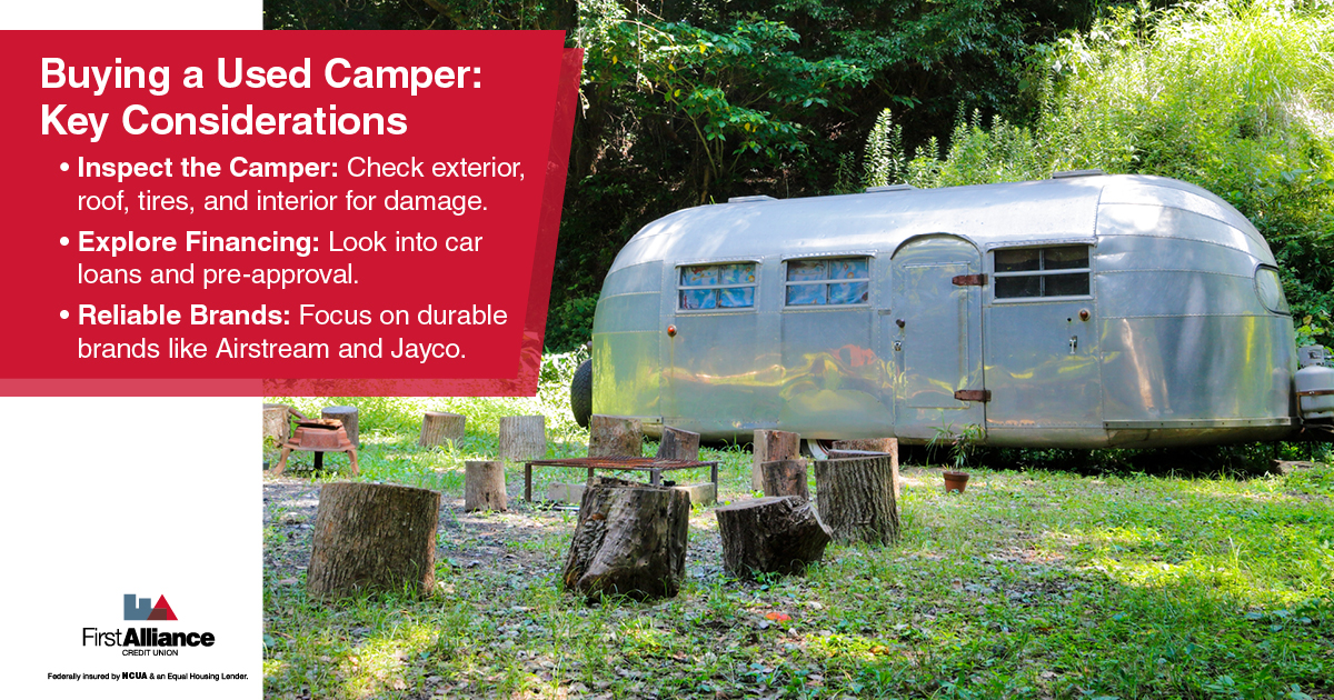 Buying a Used Camper - a silver camper in the woods