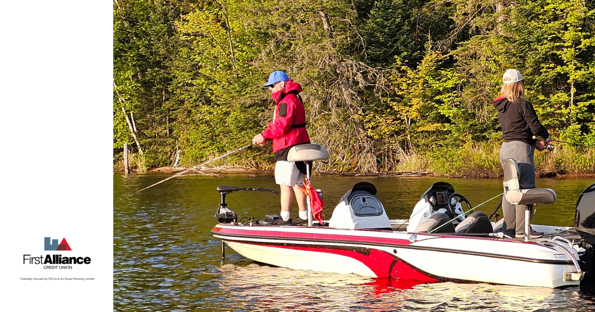 man in red coat on boat fishing with wife in a black jacket