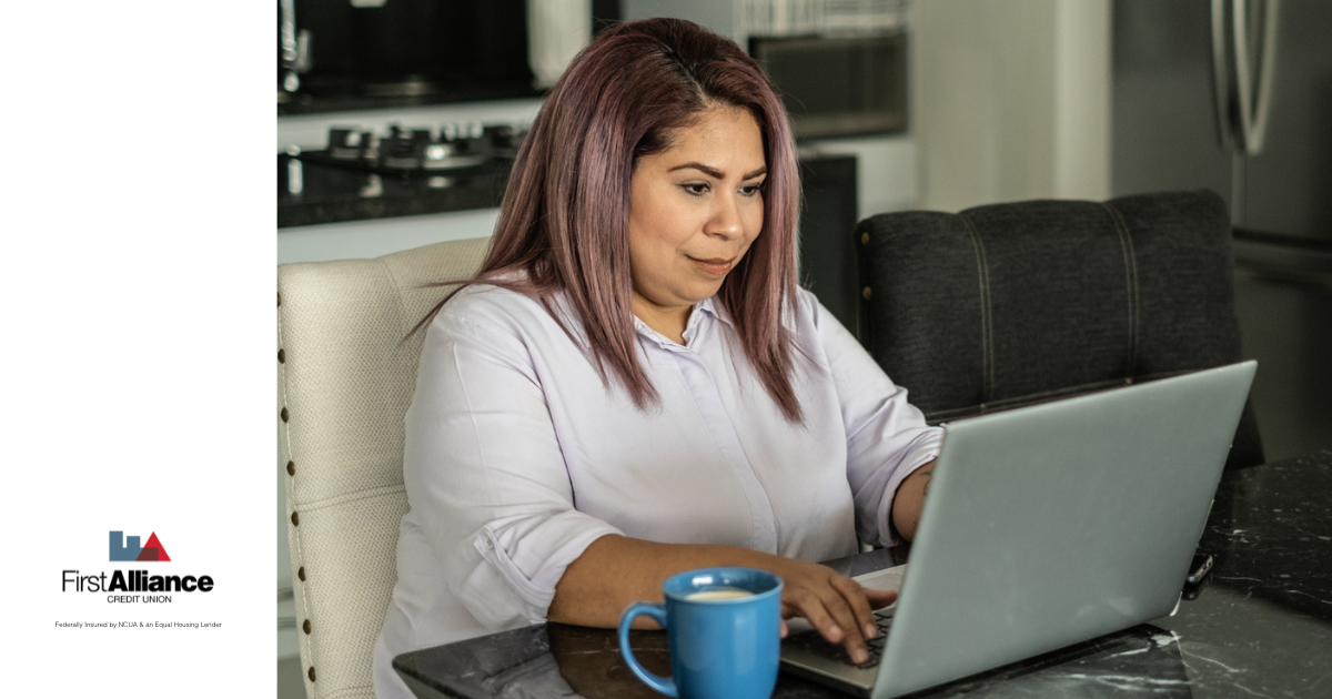 Is it better to save or pay off debt, woman with purple hair looking at computer