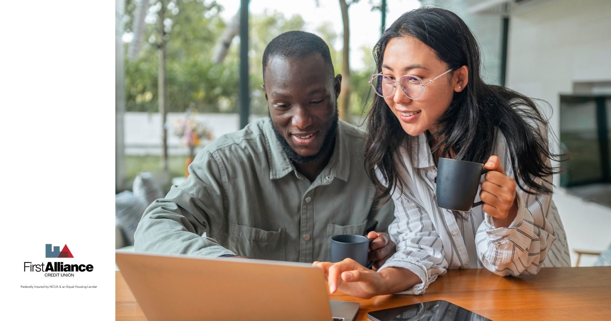 a couple having a discussion in a living room on a laptop and tablet