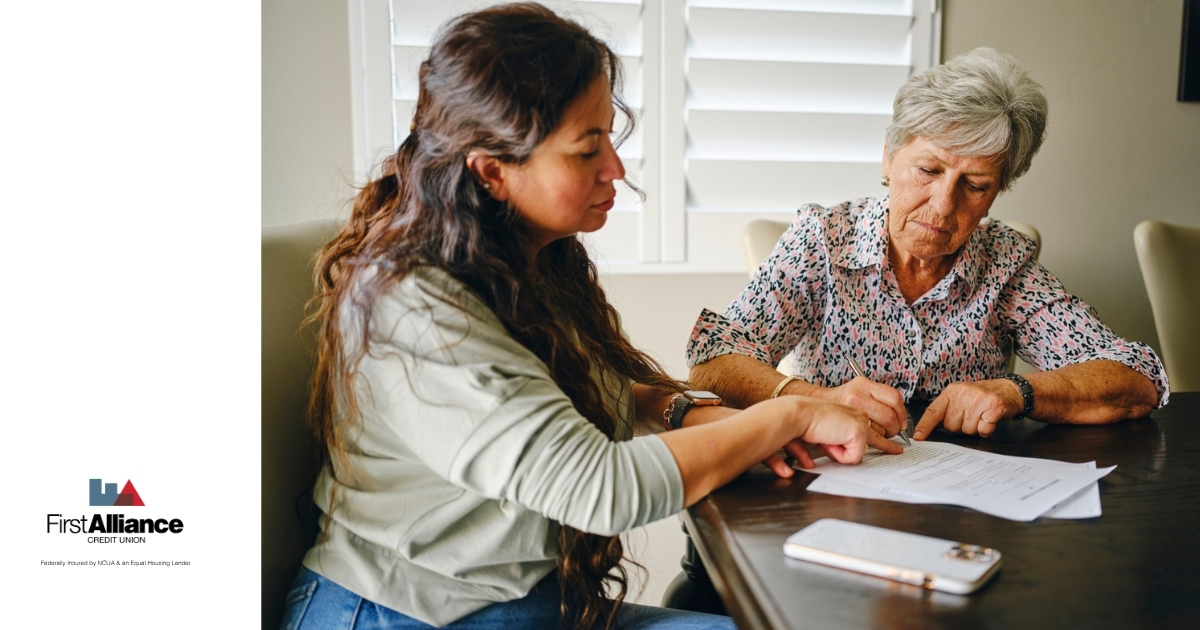 mother and daughter signing financial power of attorney papers