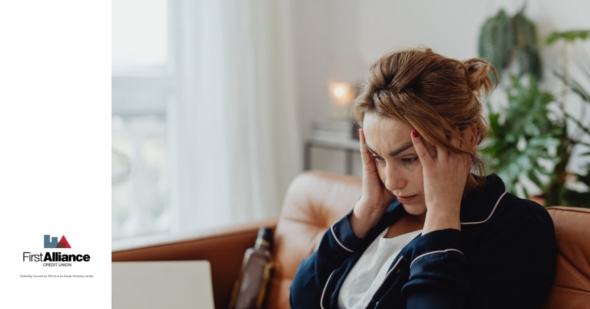 woman with hands on head looking stressed