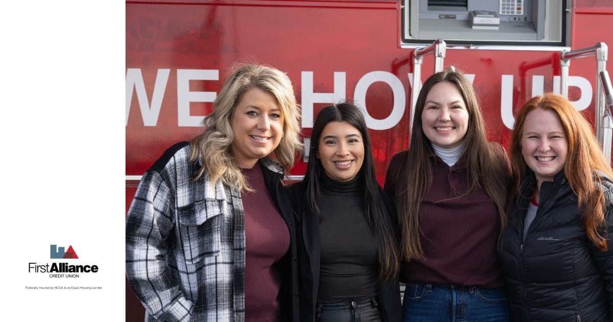 First Alliance employees smiling by mobile branch