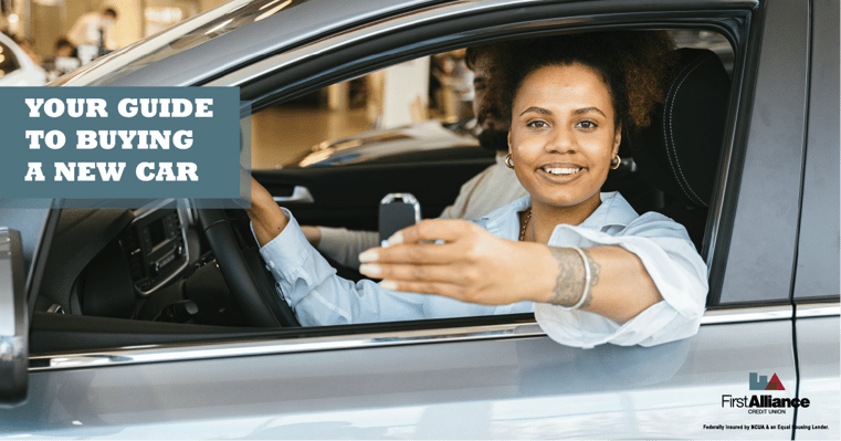 woman smiling in new car holding key - your guide to buying a new car - first alliance credit union