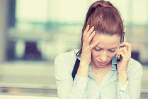 Stressed out woman talking on a phone | First Alliance Credit Union