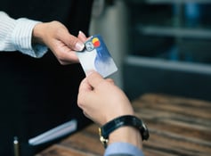 Two hands holding a credit card