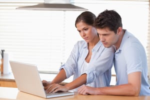 Couple using a laptop together