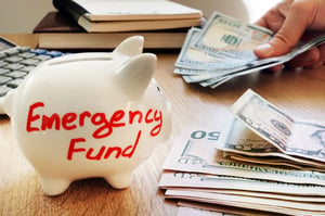 Person taking money from their emergency fund | First Alliance Credit Union