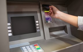 Hand inserting credit card in ATM 