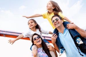 Happy family enjoying themselves on a vacation | First Alliance Credit Union 