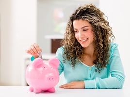 Woman saving money in piggybank