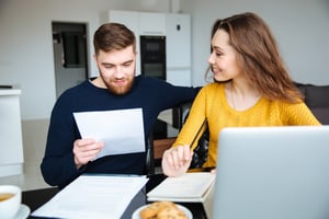 Couple transferring their bills to a new bank account.