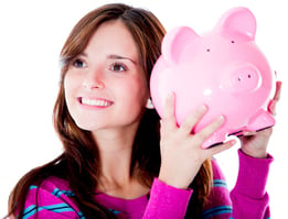 Smiling woman shaking a piggy bank