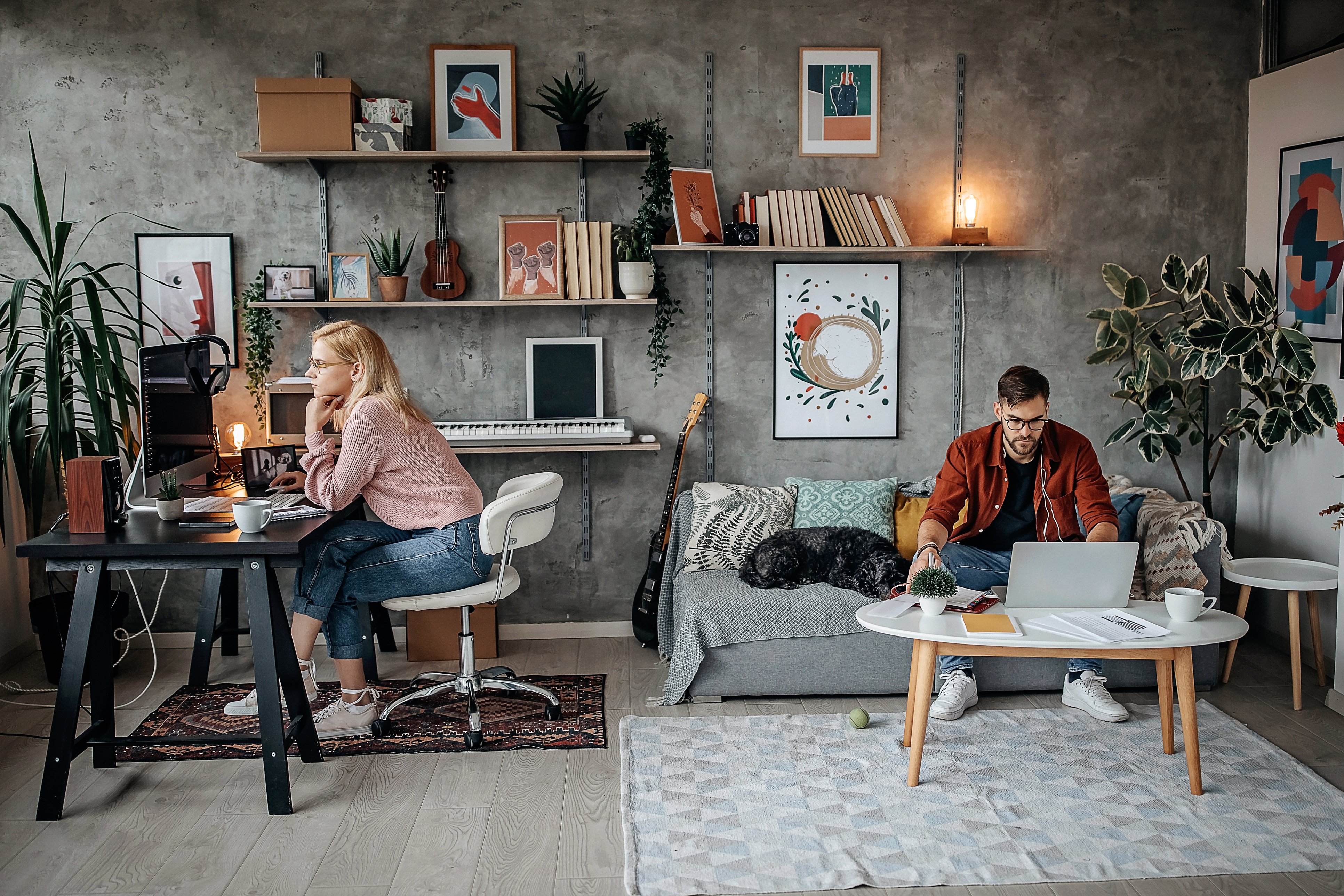 Couple working from home in a room that is far too small for both of them | First Alliance Credit Union
