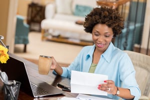 Woman smiling because her credit report isn't affected by getting a checking account