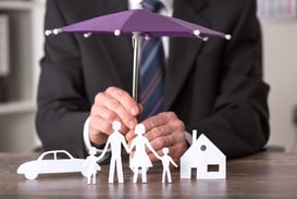 Umbrella over paper family and home