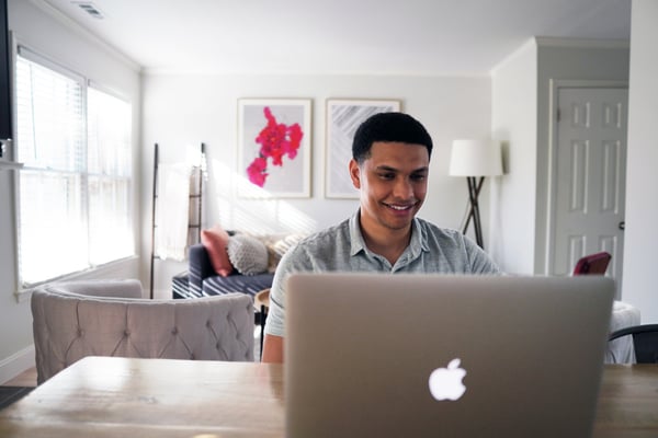 Man on laptop filling out application