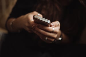 Woman's hands holding a smartphone | First Alliance Credit Union
