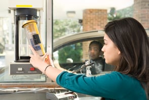 Bank teller with a pneumatic tube.