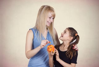 Mother giving money to daughter