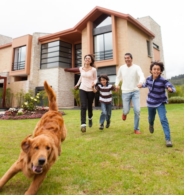 Family having fun running after the dog