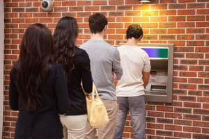 People lined up at ATM 