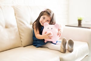 Child holding piggy bank 