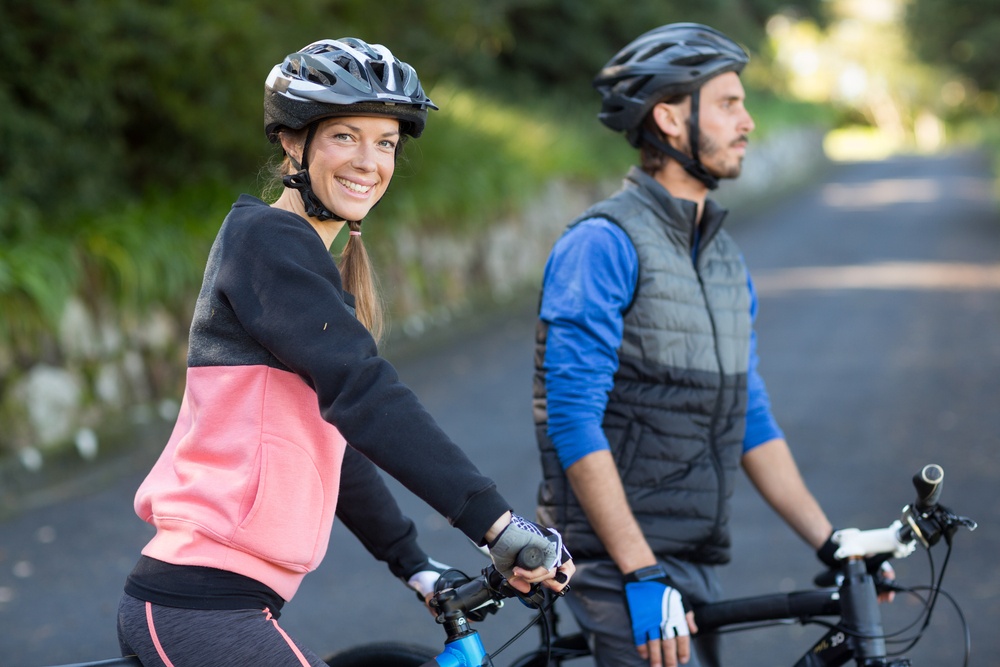 Biker couple with mountain bike on the countryside road