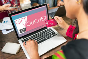Woman With Gift Card | First Alliance Credit Union