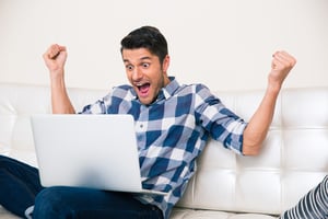 Excited man on laptop | First Alliance Credit Union