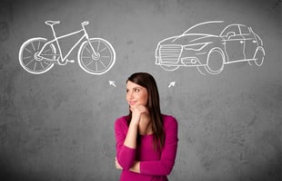 Woman thinking about car and bike