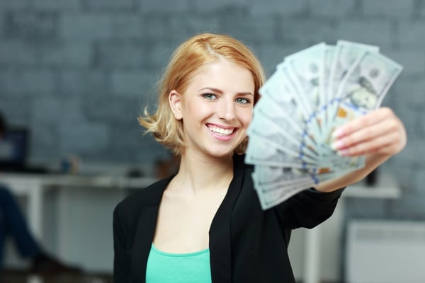 woman holding tax return money