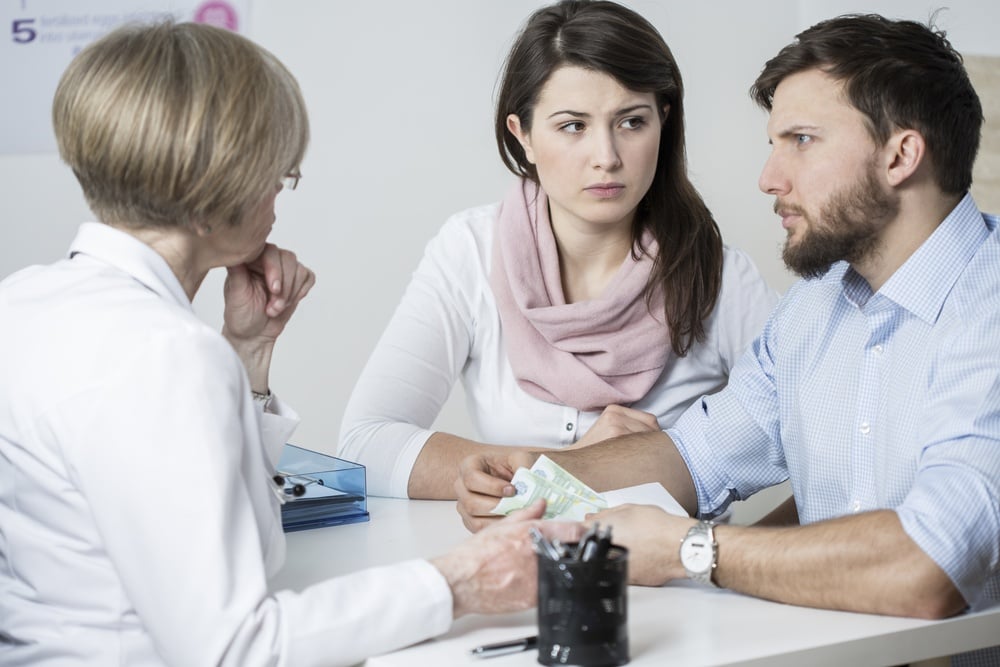 Couple talking with loan advisor