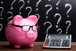 Piggy bank and calculator | First Alliance Credit Union
