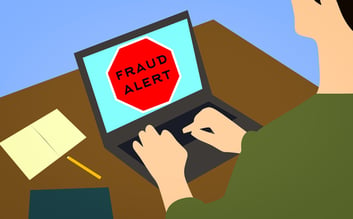 Fraud alert on laptop screen