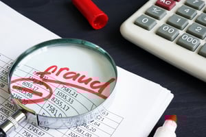 magnifying glass over Fraud