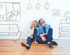 Couple sitting on floor dreaming about the future