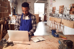 Small business owner working on a laptop | First Alliance Credit Union