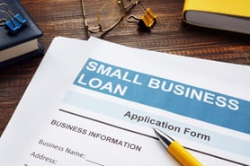 Small business loan application on desk with mechanical pencil | First Alliance Credit Union