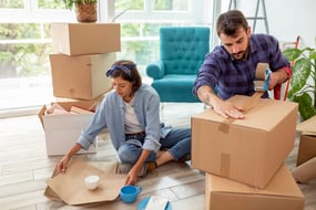 A couple packing moving boxes