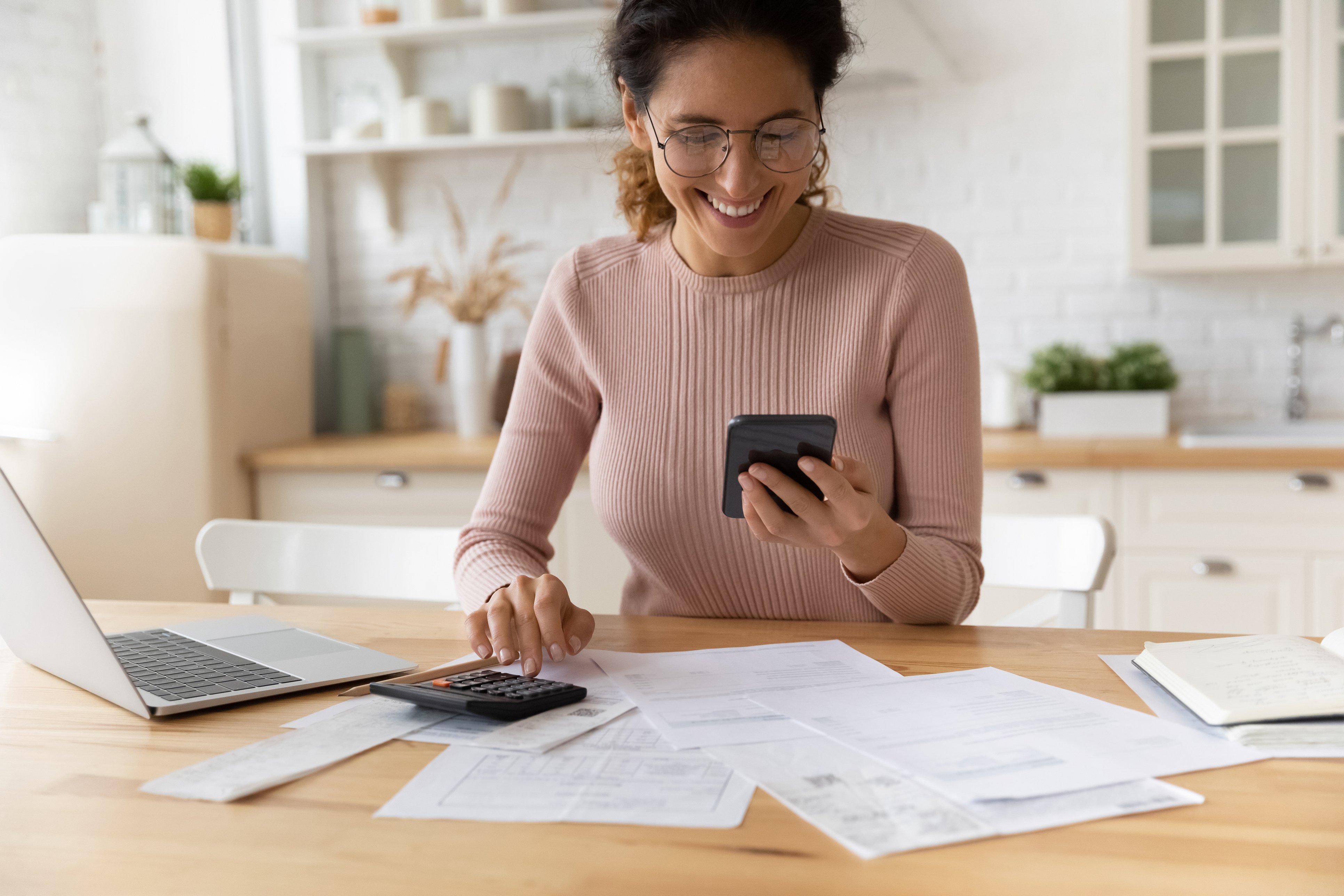 Happy woman creating budget