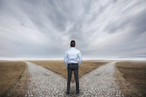 Man standing at a fork in the road