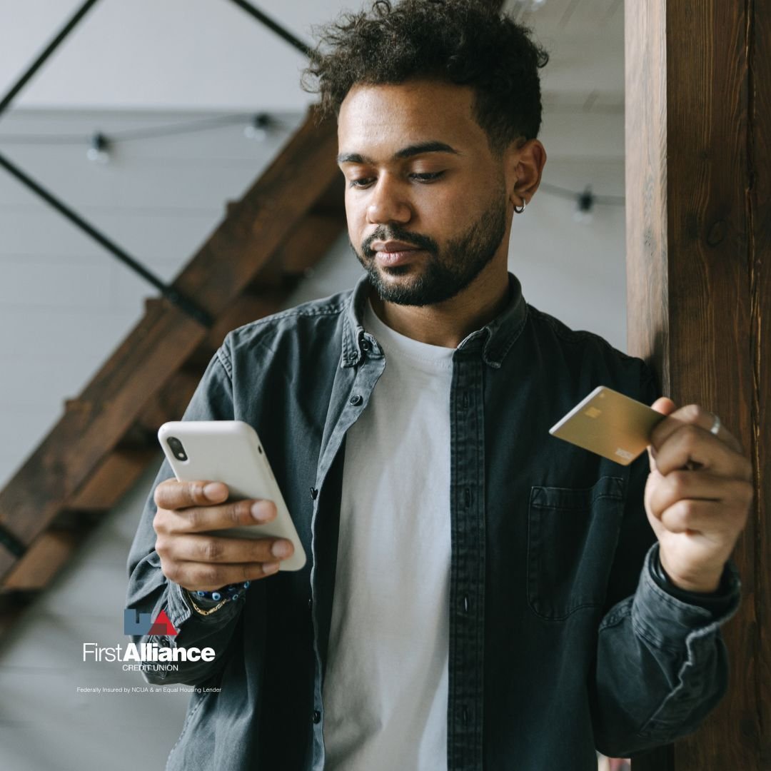 Man holding a credit card and phone