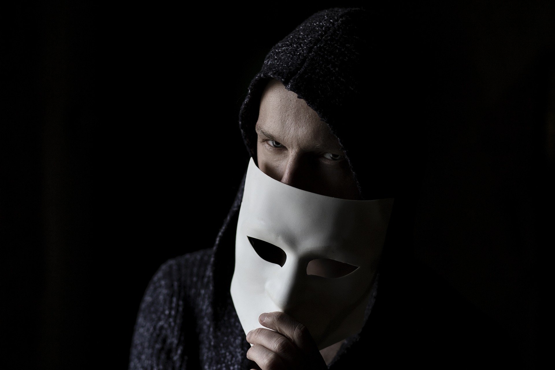 Scammer behind a mask