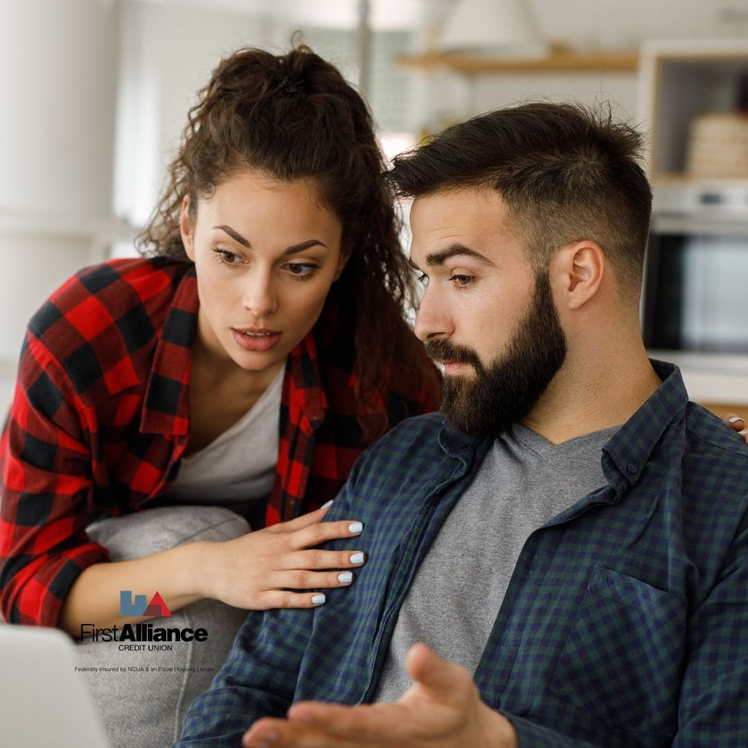 couple having a discussion looking at computer