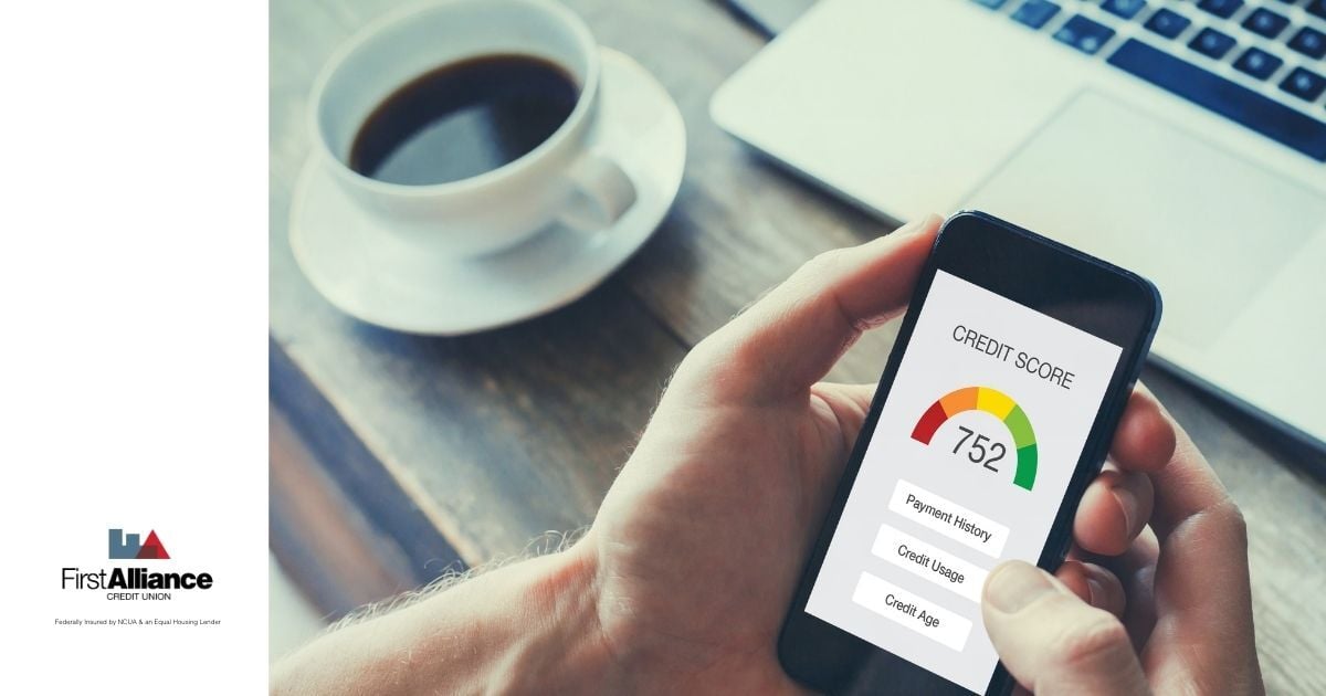 credit check on cell phone screen, cup of black coffee on table