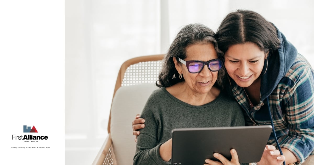 adult woman looking at tablet with adult child