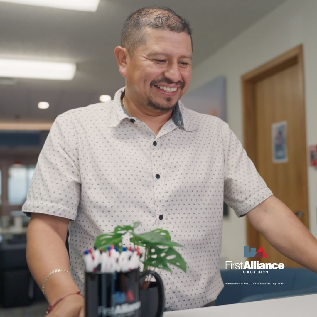 First Alliance Credit Union member in branch smiling